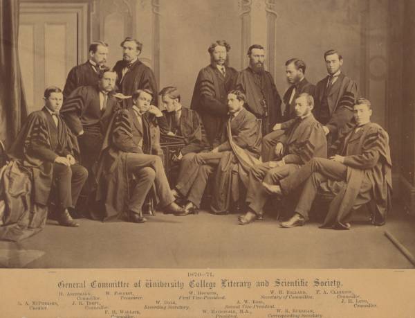 Twelve men in suits and academic robes