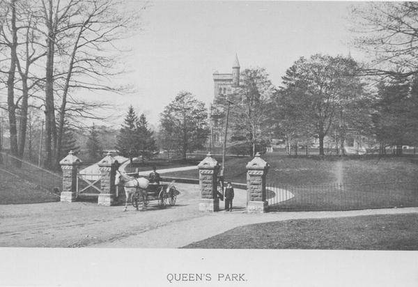 Horse and buggy between gates of park, with University College in distance