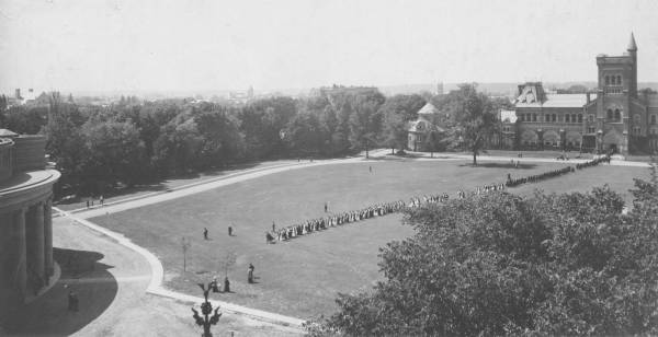aerial view of Front Campus showing over 100 people in academic robes walking from University College to Convocation Hall
