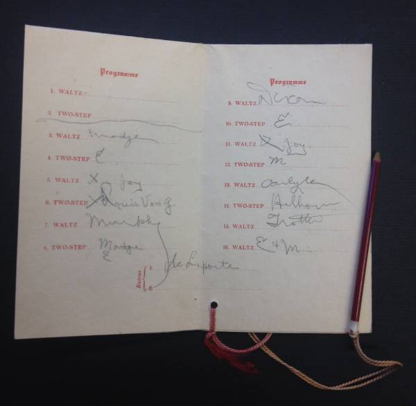 Inside of a dance card with list of dances and pencilled names