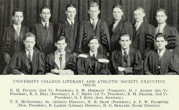 Twelve men in suits and academic robes