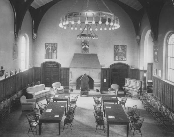 room with tables, chairs, a fireplace, and large windows