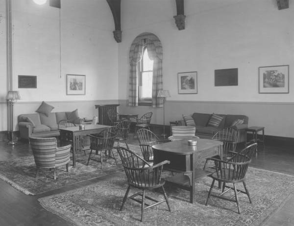room with tables, chairs, and sofas