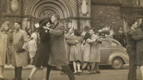 Men and women dancing in front of the main entrance of University College