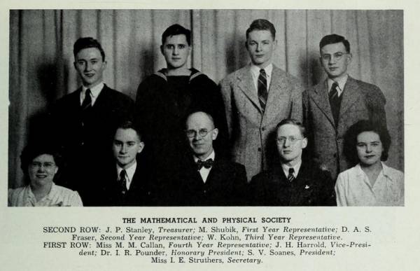 Group portrait of seven men and two women.