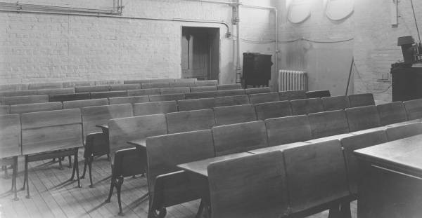 classroom with about eight rows of wooden desks