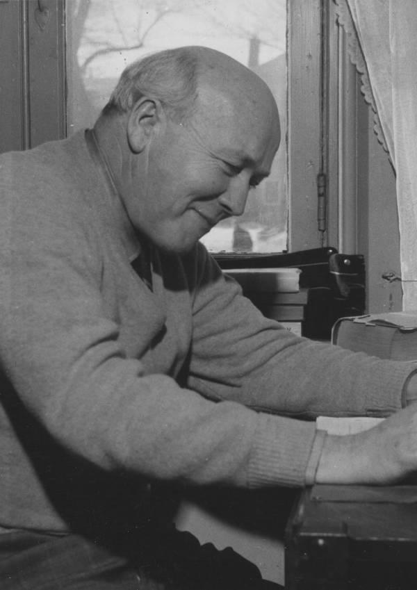 Professor Walter Bauer seated at desk