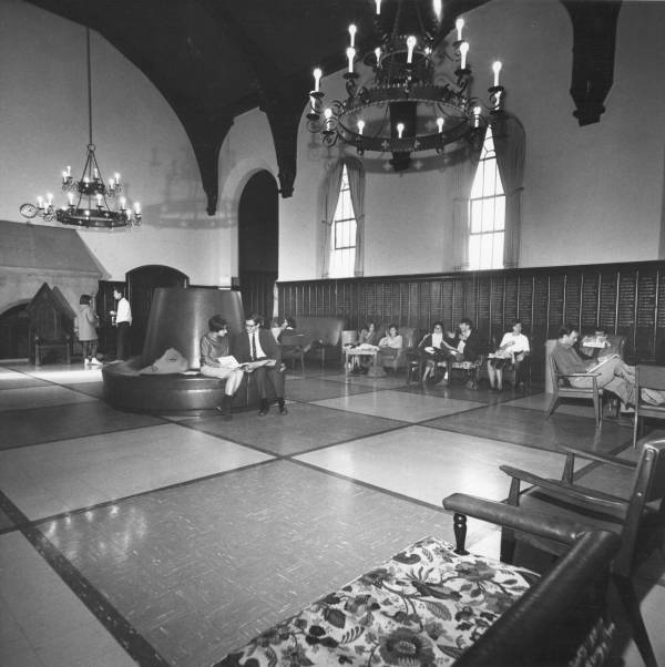 about ten students talking or reading in the Junior Common Room