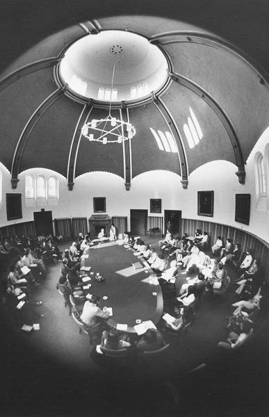 Many people seated around large table in Croft Chapter House