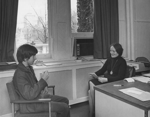 A woman talking with a young man