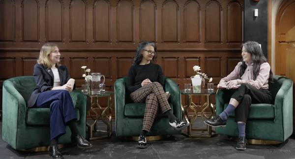 Suzette Mayr, Sheila Heti and Thea Lim seated in green chairs on-stage at UC