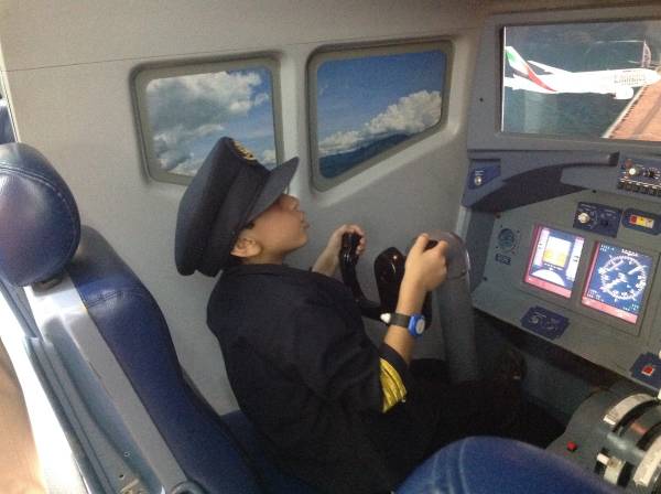 four-year-old boy flying a Boeing 777 simulator