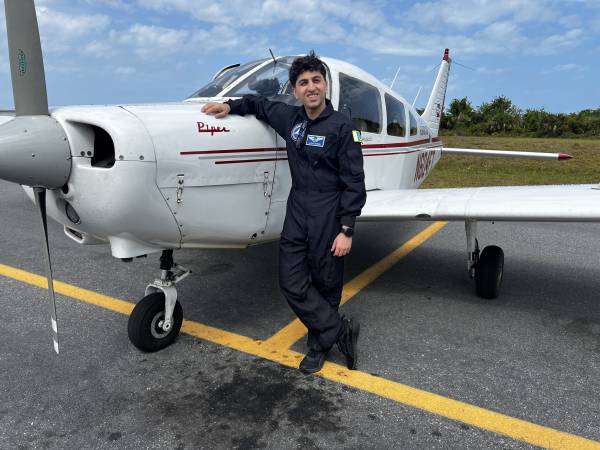 Hasaan Mohsin in front of small plane