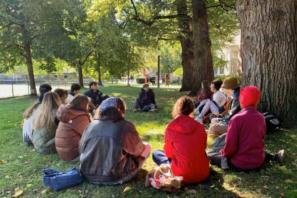 students sitting in a circle with alan ackerman