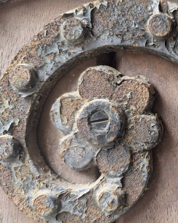 Macro image of rusted metal on a wooden door at UC