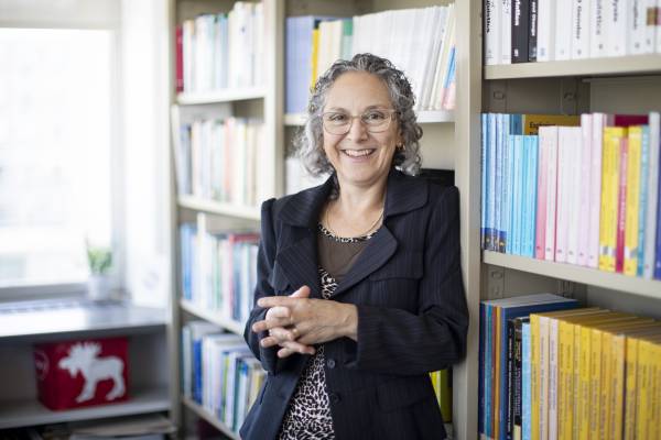 Sali Tagliamonte leaning against books
