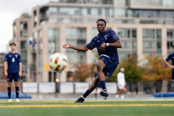 kinglsey belele kicking soccer ball