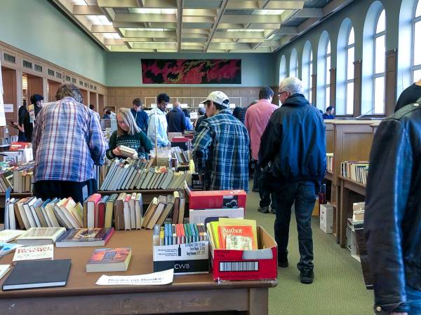 Booksale goers leafing through books