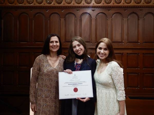 Elbieta and family take photo with diploma