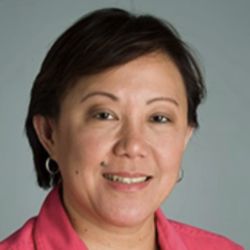 Headshot of Cynthia Goh, smiling at the camera wearing a pink shirt.
