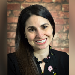 Headshot of Prof. Shelley Bolotin, wearing a black shirt, smiling at the camera.
