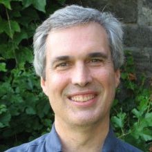 Philip Sohm, smiling at the camera, wearing a blue shirt.