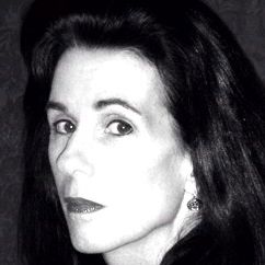 Black and white headshot of Elizabeth Harvey staring at the camera with a black jacket on.