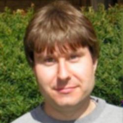 Christopher Klinger, looking at the camera, wearing a grey sweatshirt.