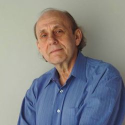 Rick Salutin, smiling at the camera, wearing a blue shirt.